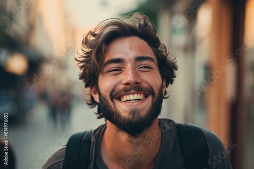 Portrait of a happy young man with a beaming smile, enjoying life on a city street