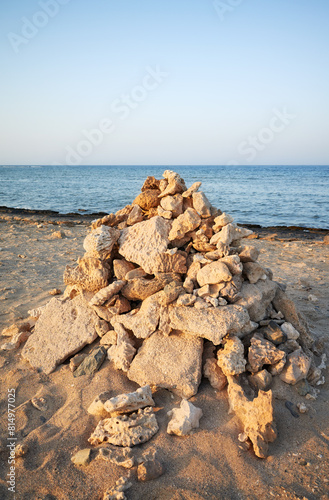 Pyramid of coral and stones on the beach, selective focus, Egypt.