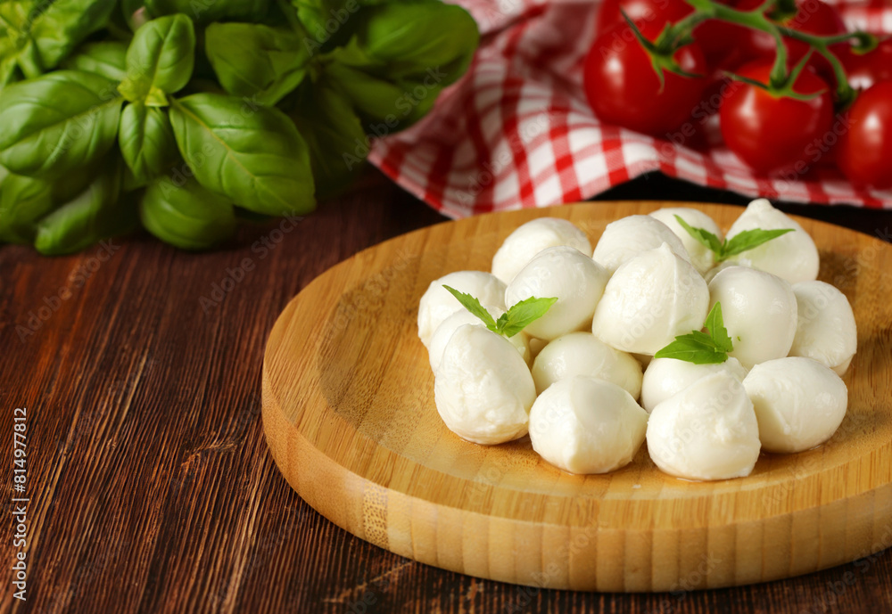 fresh organic mini mozzarella cheese on a wooden board fresh organic mini mozzarella cheese on a wooden board