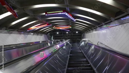 moving down long escalator at exchance place (colorful lights, moving stairs) photo