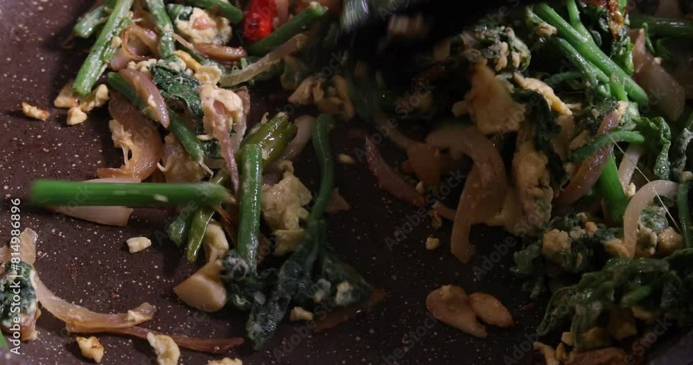 Stir fry tossing pumpkin leaf onion garlic chilli salt egg oil delicacy in frying pan Stir fry tossing pumpkin leaf onion garlic chilli salt egg oil delicacy in frying pan