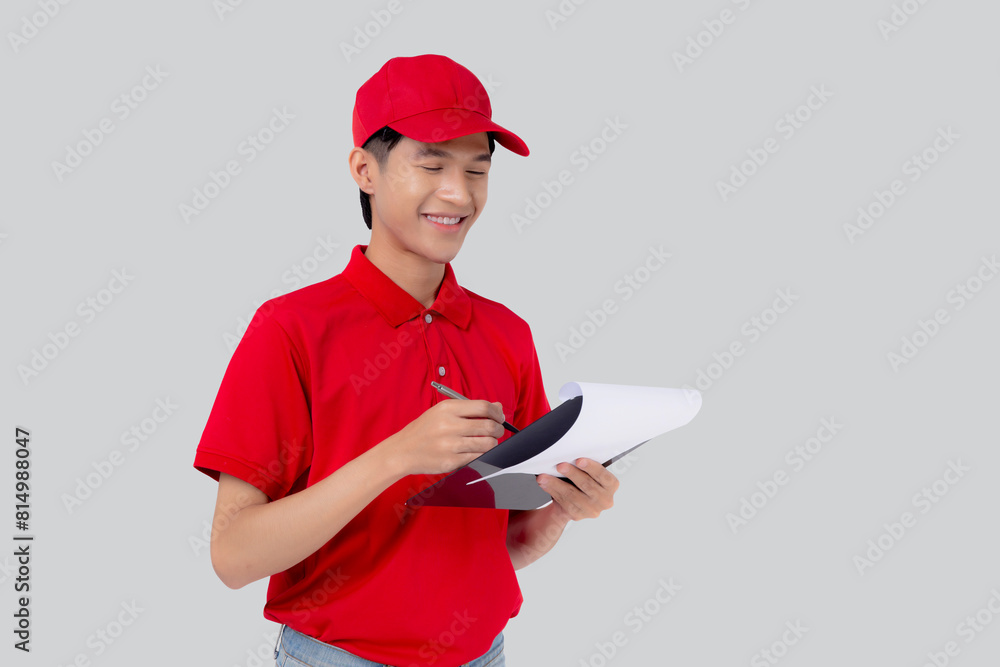 Young delivery asian man in red uniform and looking document on clipboard and writing isolated white background, employee reviewing order details, courier and delivery, logistic and cargo. Young delivery asian man in red uniform and looking document on clipboard and writing isolated white background, employee reviewing order details, courier and delivery, logistic and cargo.