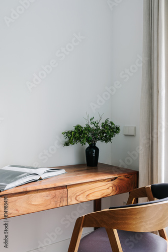 study space with wooden desk and chair, with plenty of natural light photo