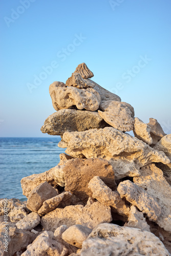 Close up photo of pyramid made of coral on a beach at sunset, selective focus, Egypt.
