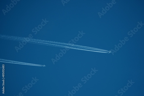 two parallel airplane tracks in the blue sky, contrails