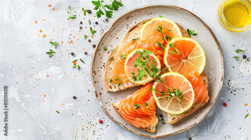 Open sandwich with smoked salmon on round plate, white background, top view