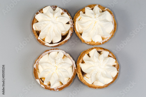 Small tarts with custard top on gray background, top view © An-T