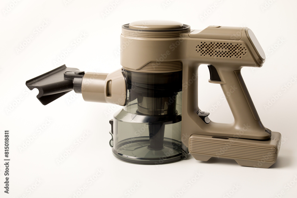 Handheld cordless vacuum cleaner for collecting dust and small particles from floors and other surfaces. Plastic vacuum cleaner brush designed for cleaning furniture, white background Handheld cordless vacuum cleaner for collecting dust and small particles from floors and other surfaces. Plastic vacuum cleaner brush designed for cleaning furniture, white background