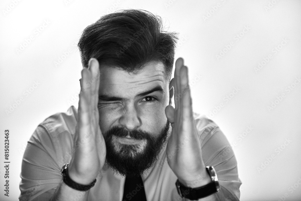Emotional portrait of a man with a beard in a white shirt. Grain effect used Emotional portrait of a man with a beard in a white shirt. Grain effect used