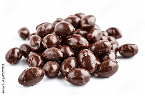 a pile of chocolate covered almonds on a white surface
