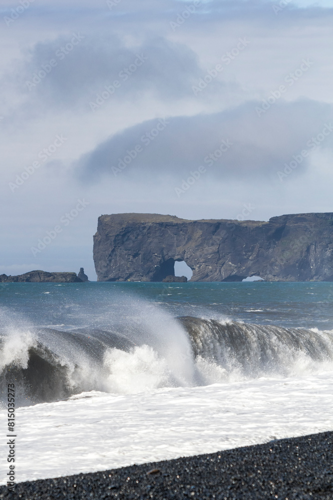 waves crashing at the black sand beach of Reynisfjara with an stunning mountain range in the distance, Iceland waves crashing at the black sand beach of Reynisfjara with an stunning mountain range in the distance, Iceland