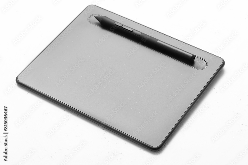 Top view of graphic tablet and pen for illustrators, designers and photographers on light background. 3d rendering Top view of graphic tablet and pen for illustrators, designers and photographers on light background. 3d rendering