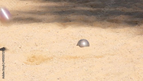 playing bocce balls on sandy beach photo