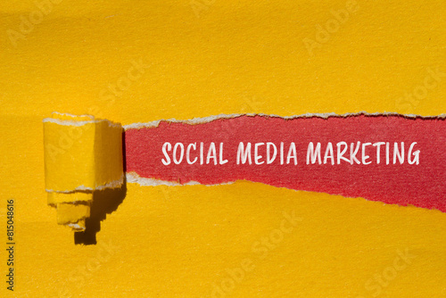 Social media marketing words written on ripped yellow paper with red background. Conceptual social media marketing symbol. Copy space.