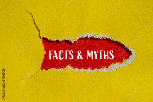 Fotografie Facts and myths words written on ripped yellow paper with red background