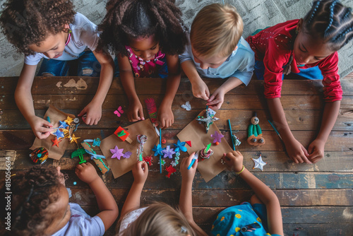 Mixed-race children making Memorial Day crafts in an overhead perspective. photo