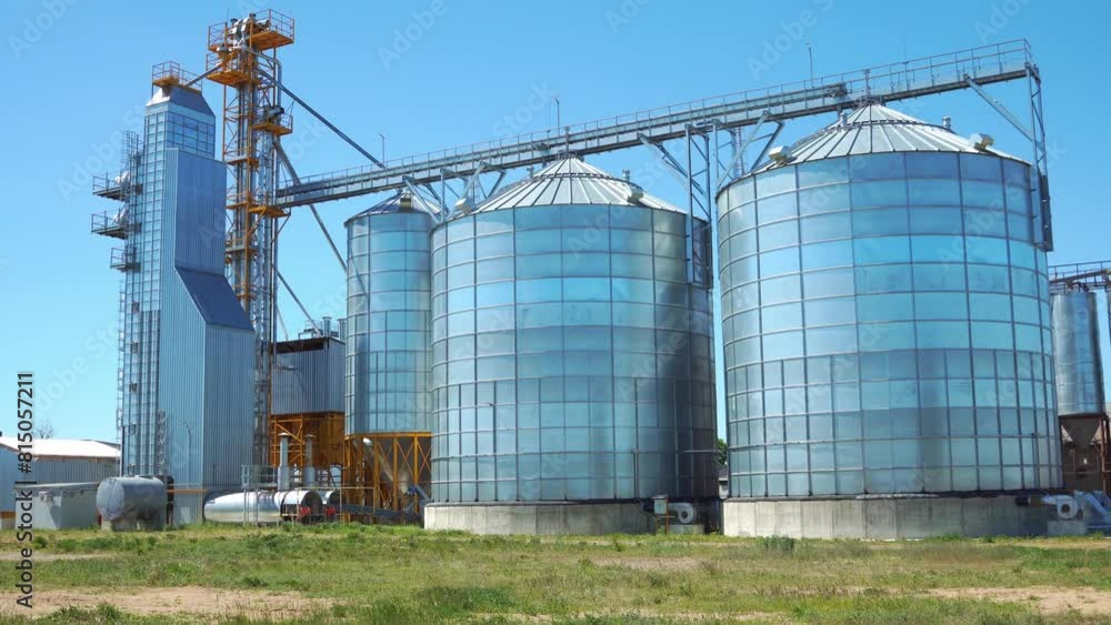 Silver silos. View of an agro-industrial plant for processing, drying, cleaning and storage of agricultural products, flour, cereals and legumes. Silver silos. View of an agro-industrial plant for processing, drying, cleaning and storage of agricultural products, flour, cereals and legumes.