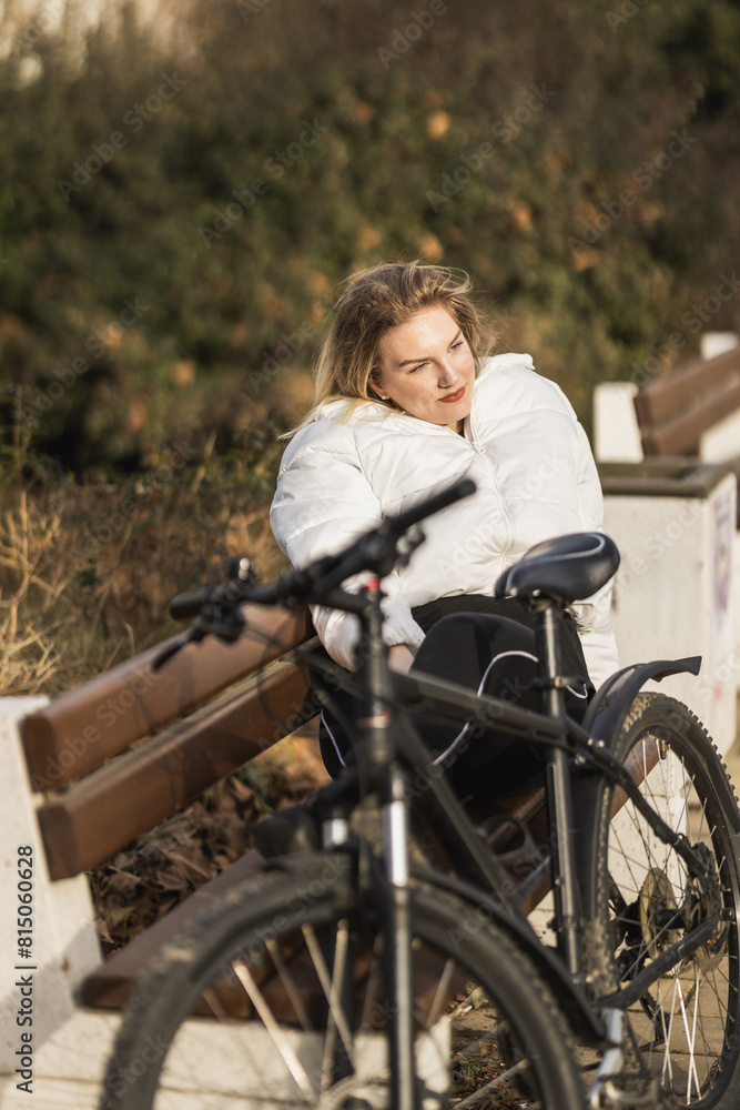 Woman Enjoying Sunny Day on Park Bench Next to Bike Woman Enjoying Sunny Day on Park Bench Next to Bike