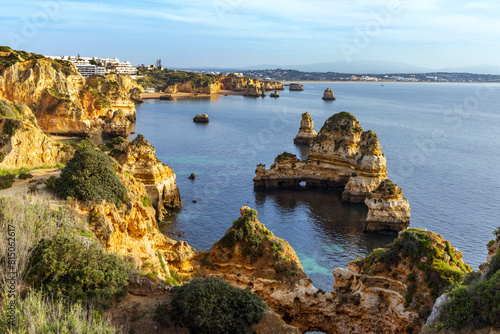 Spectacular stacks and cliffs of Praia dos Pinheiros and Praia do Camilo in Lagos, Algarve, Portugal. photo