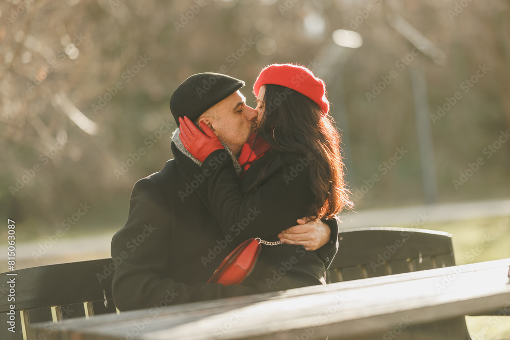 Couple Embracing and Kissing on a Park Bench Couple Embracing and Kissing on a Park Bench