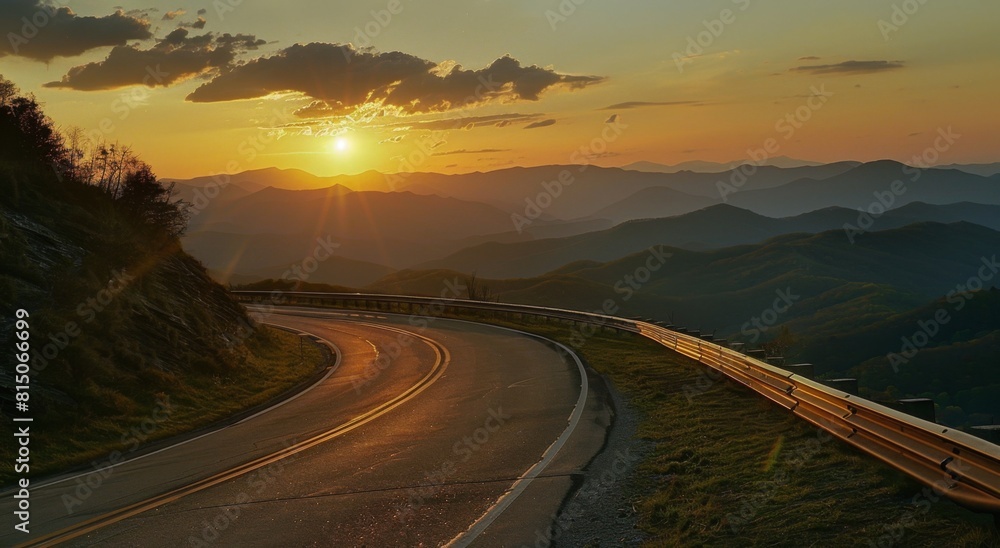 Fototapeta premium A beautiful road in the mountains with an open sky at sunset, with a asphalt surface and guardrail on both sides of it.
