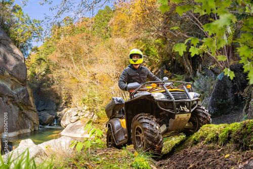 Man on ATV in mountains. Gu...