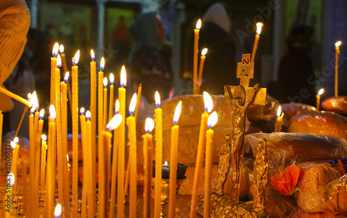 Panakhida, funeral liturgy in the Orthodox Church. Christians light candles in front of the Orthodox cross with a crucifix, pray for the dead. The concept of Orthodox faith and religion.