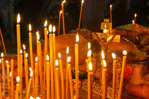 Panakhida, funeral liturgy in the Orthodox Church. Christians light candles in front of the Orthodox cross with a crucifix, pray for the dead. The concept of Orthodox faith and religion.