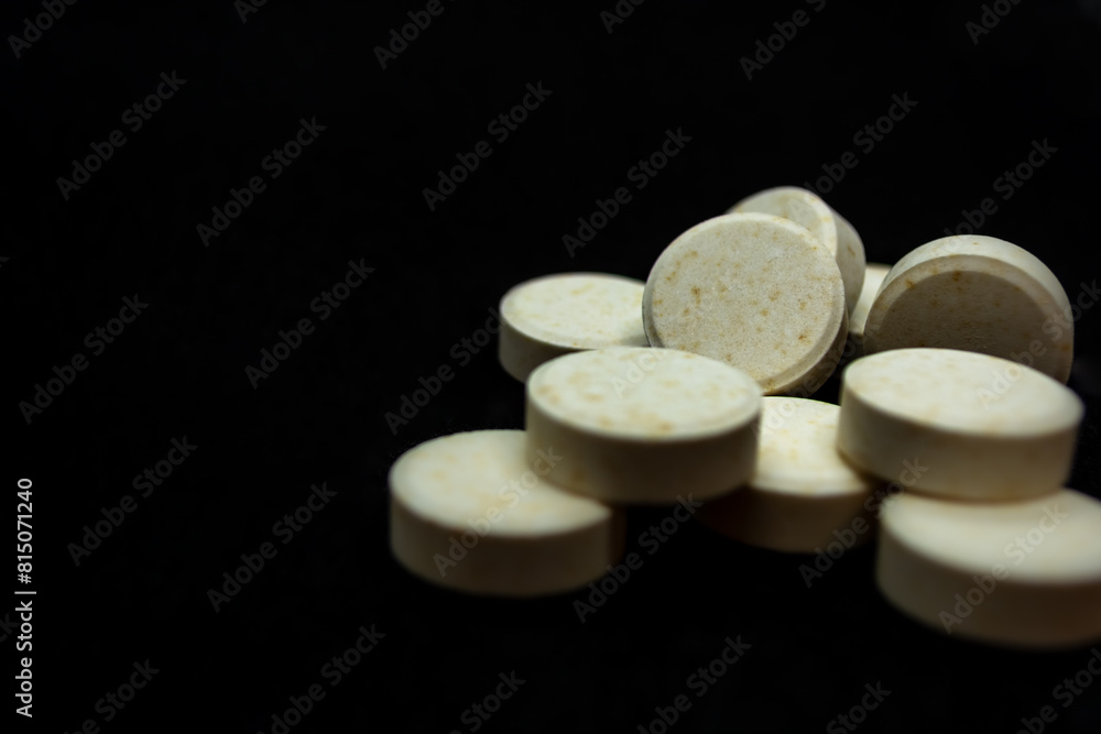 Pills on a black background. Focus on foreground, soft bokeh. Pills on a black background. Focus on foreground, soft bokeh.