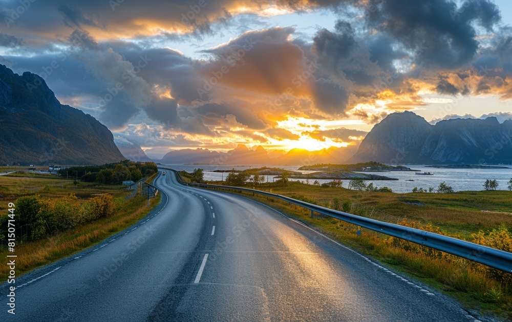 Fototapeta premium A scenic road winding through the mountains under a beautiful sunset, with a clear sky and distant hills