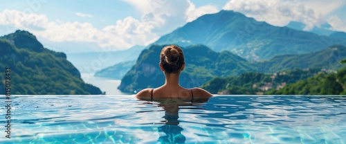 Sexy Woman Relaxing In Infinity Swimming Pool Looking At Stunning Mountain View At. With Copy Space   Background