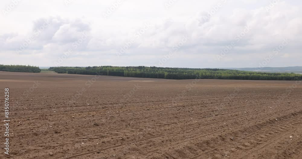 the plowed soil of a fertile field in spring, the soil in an agricultural field in cloudy weather