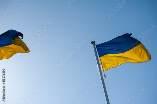ukrainian national flag waving against the blue sky.
