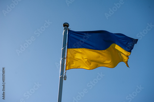 ukrainian national flag waving against the blue sky.