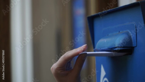 girl sends a letter. woman sends a letter by mailbox