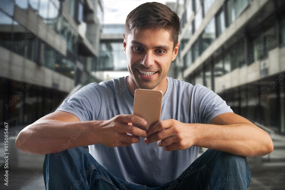 Upset businessman read message on smartphone on the city street Upset businessman read message on smartphone on the city street