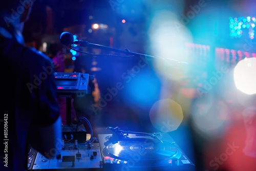 DJ performs in a nightclub at a party.