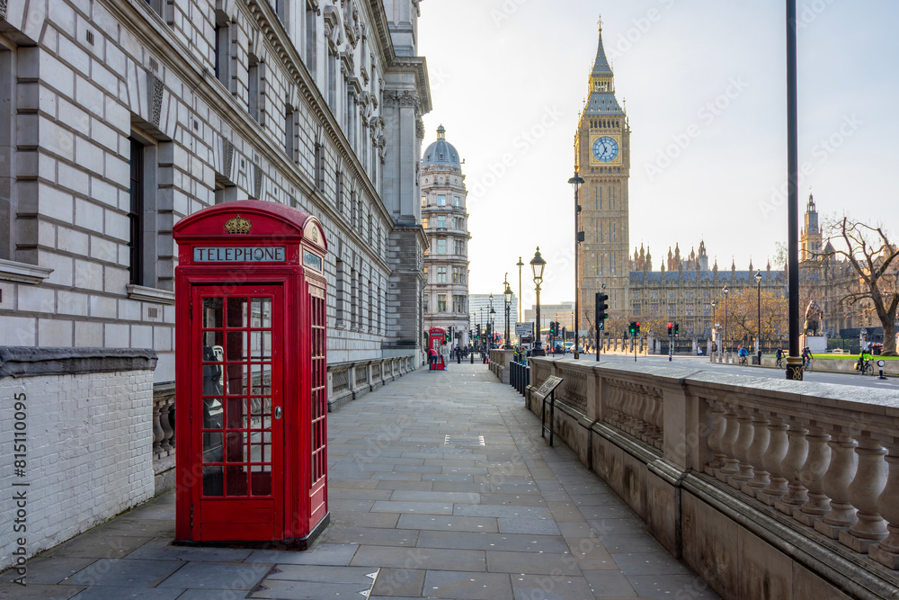Red telephone box on Parliament square and Big Ben tower, London, UK