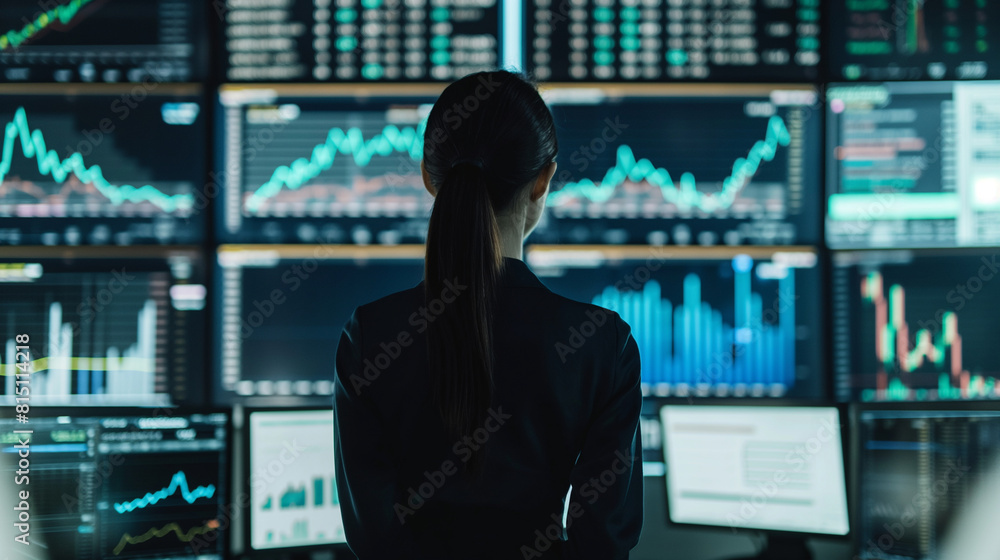 Businesswoman conducting stock market analysis in a minimalist office Businesswoman conducting stock market analysis in a minimalist office