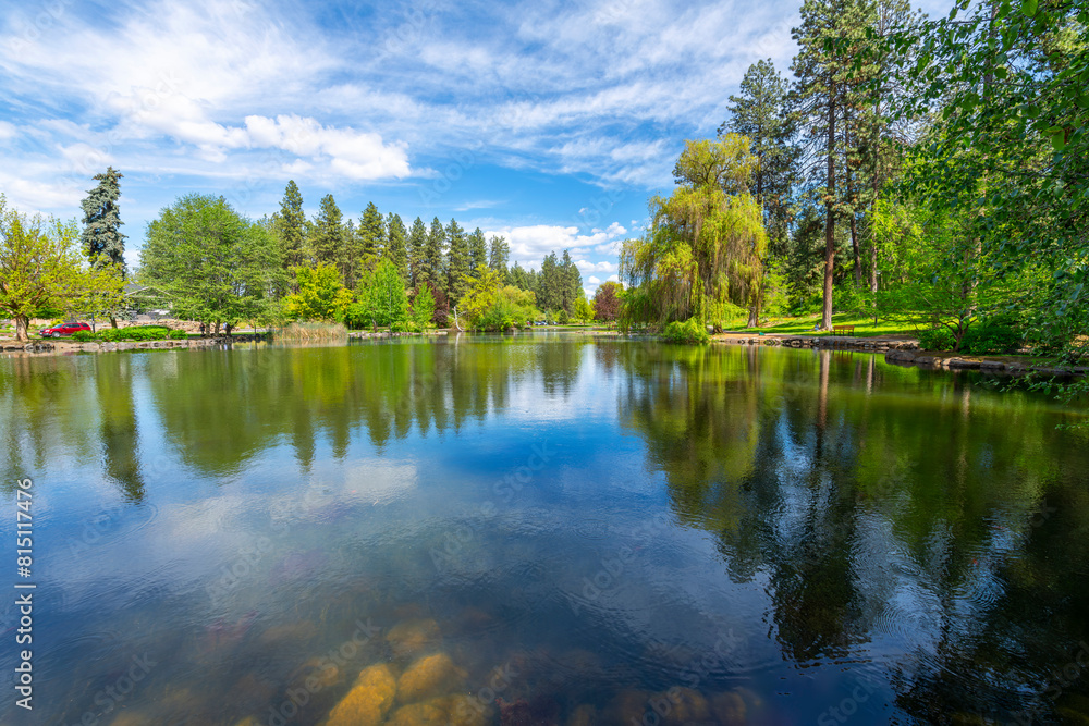 The landscaped gardens surrounding Mirror Pond at the public Manito Park and Botanical Gardens in the South Hill downtown district of Spokane, Washington. The landscaped gardens surrounding Mirror Pond at the public Manito Park and Botanical Gardens in the South Hill downtown district of Spokane, Washington.