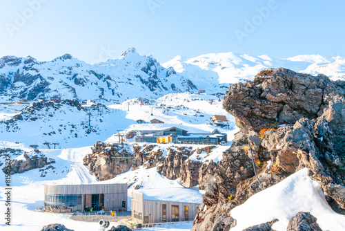 Φωτογραφία Whakapapa ski-field and facilities buildings on shady side of mountain as sun ri