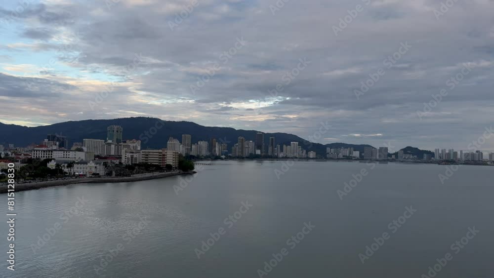 sunrise timelapse of George Town, Penang, Malaysias shorefront skyline with hotels, the bay, beachfront on a cloudy day sunrise timelapse of George Town, Penang, Malaysias shorefront skyline with hotels, the bay, beachfront on a cloudy day
