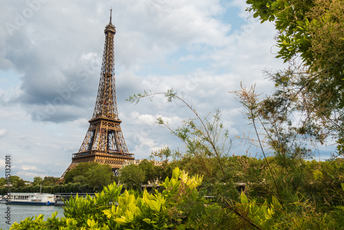 Eiffel Tower viewed from the banks with frame of vegetation