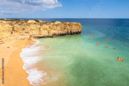 View of cliffs and canoes on ocean, beach near Albufeira, Portugal