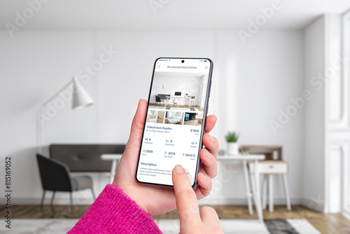 Woman's hands holding a smartphone displaying a residential real estate app. Modern technology, property search for a seamless and convenient real estate exploration experience