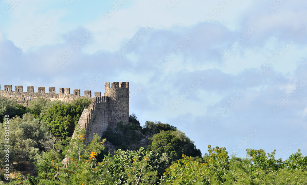 Part of castle wall with tower at the tip, medieval village of Óbidos in Portugal Part of castle wall with tower at the tip, medieval village of Óbidos in Portugal
