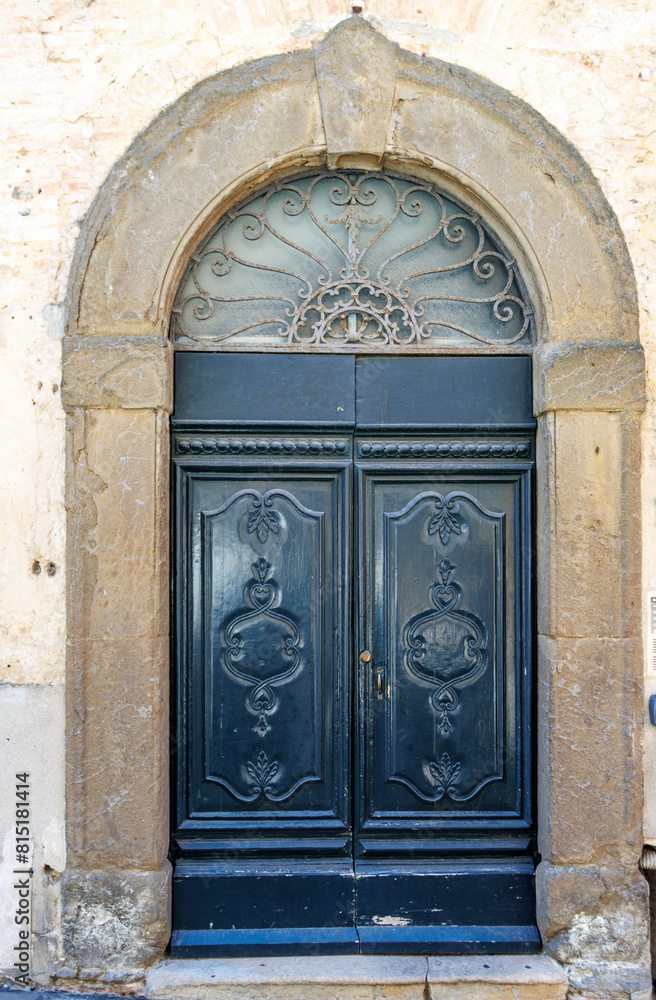 Ornate green door in the old center in Volterra, Tuscany, Italy, Europe Ornate green door in the old center in Volterra, Tuscany, Italy, Europe