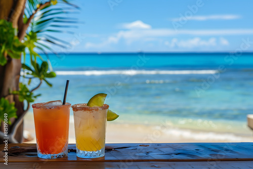 Two colorful drinks served at a rustic beach bar looking out over the ocean photo