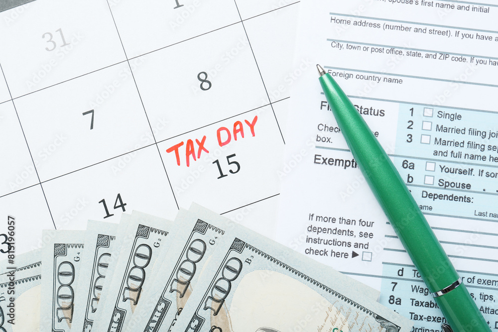 Tax day. Document, dollar banknotes and pen on calendar with date reminder, flat lay Tax day. Document, dollar banknotes and pen on calendar with date reminder, flat lay