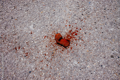 A rusted piece of metal of unknown origin lies on the asphalt in Austin, Texas